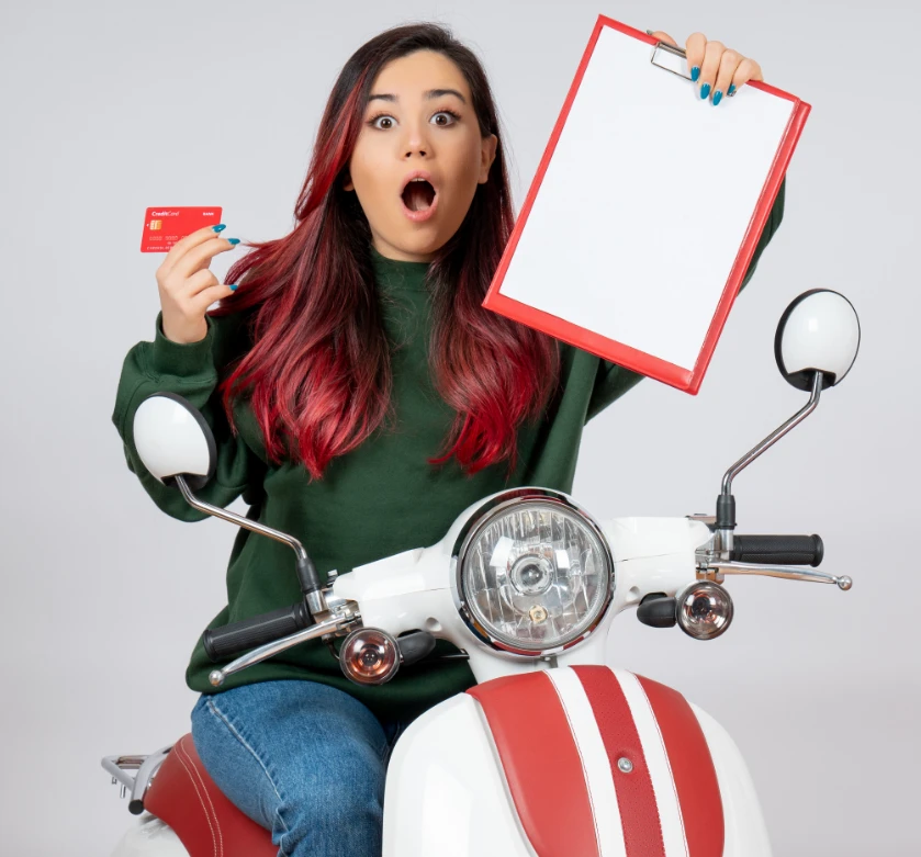front-view-young-female-motorcycle-holding-note-bank-card-white-wall